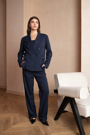 Dark blue/navy double-breasted pinstripe blazer with 4 buttons and shoulder pads - work outfit, corporate outfit - front view